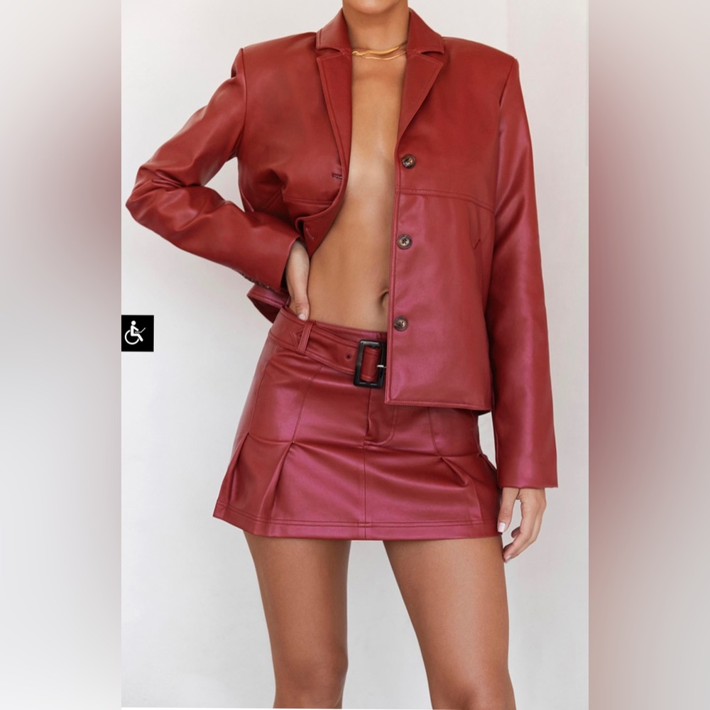 Mistress rocks vegan leather jacket and mini skirt